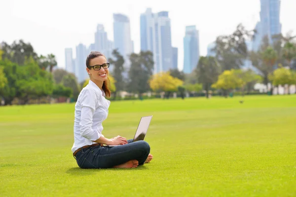 Femme avec ordinateur portable dans le parc — Photo
