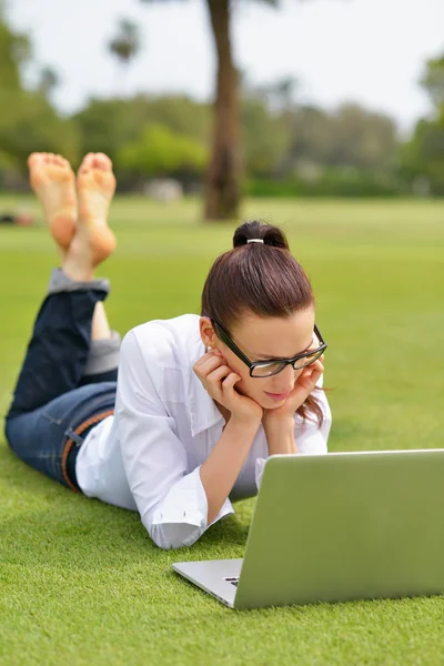 Femme avec ordinateur portable dans le parc — Photo