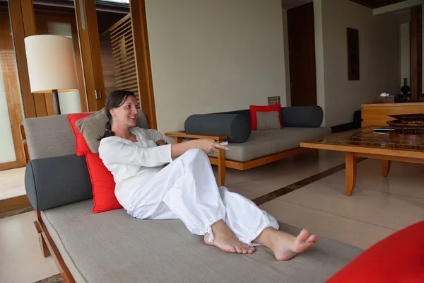 Happy young woman relax at home on sofa — Stock Photo, Image