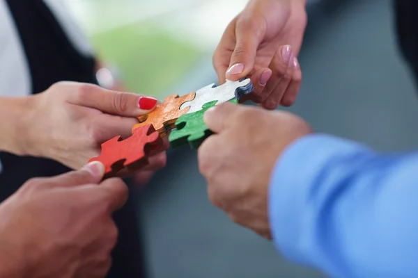 Group of business people assembling jigsaw puzzle — Stock Photo, Image