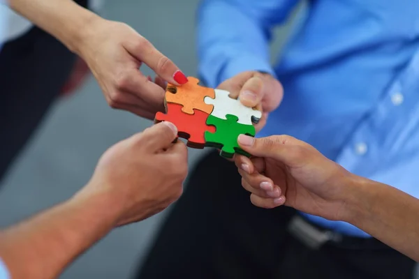 Group of business people assembling jigsaw puzzle — Stock Photo, Image