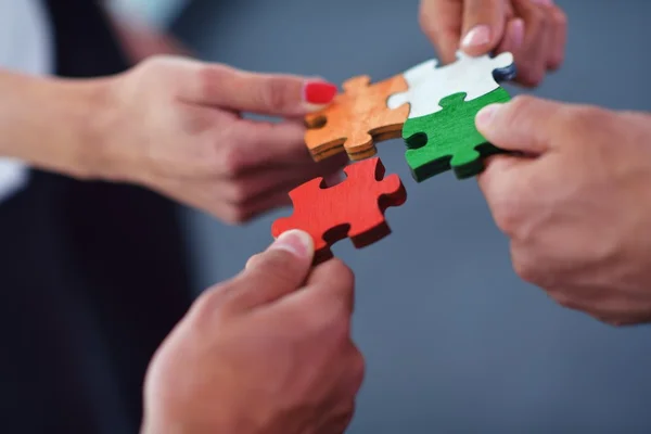 Group of business people assembling jigsaw puzzle — Stock Photo, Image
