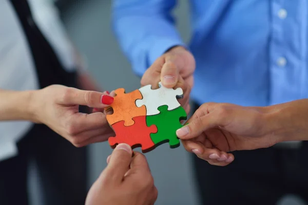 Group of business people assembling jigsaw puzzle — Stock Photo, Image