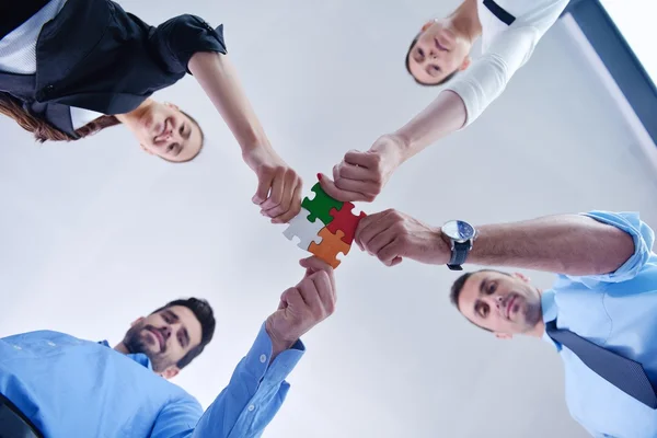 Group of business people assembling jigsaw puzzle — Stock Photo, Image