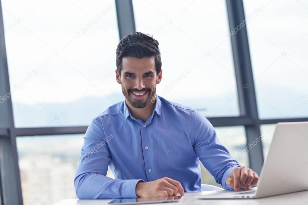 happy young business man at office