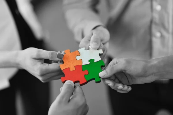 Group of business people assembling jigsaw puzzle — Stock Photo, Image