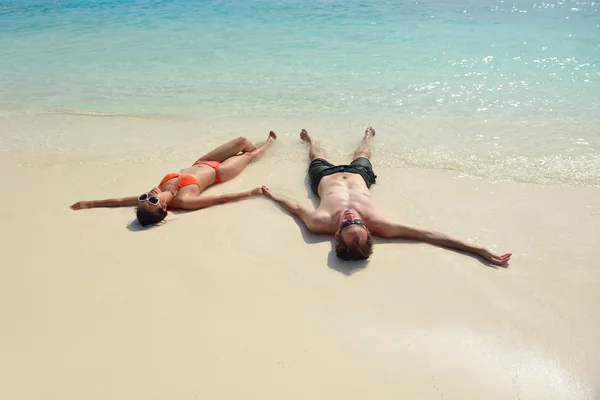 Feliz pareja joven divertirse en la playa — Foto de Stock