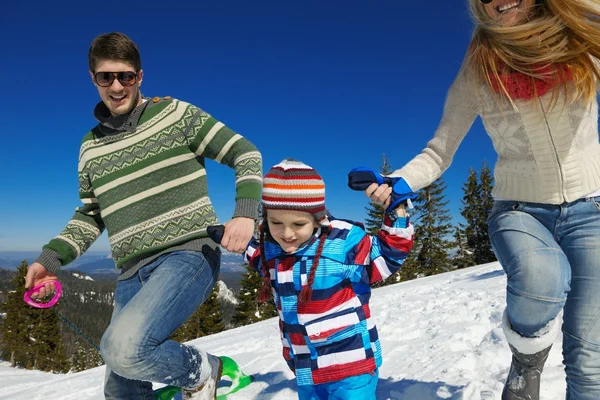 Family having fun on fresh snow at winter vacation — Stock Photo, Image