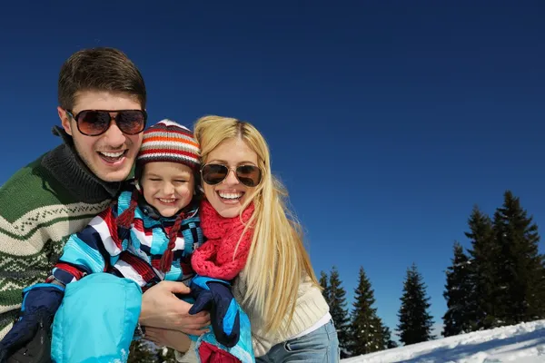 Family having fun on fresh snow at winter vacation — Stock Photo, Image