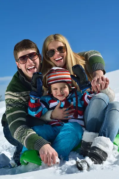 Family having fun on fresh snow at winter vacation — Stock Photo, Image