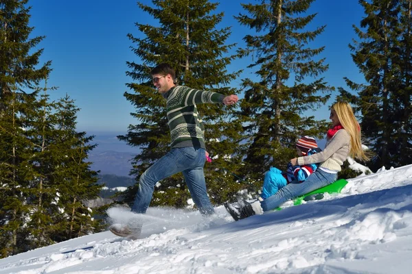 Family having fun on fresh snow at winter vacation — Stock Photo, Image