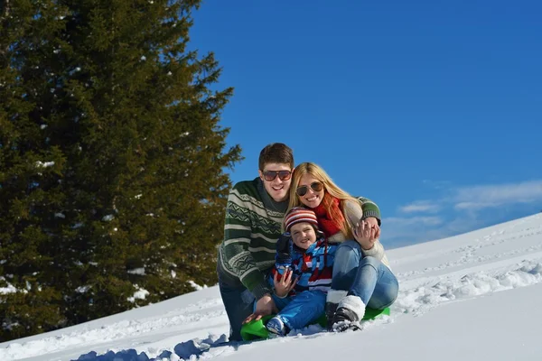 Family having fun on fresh snow at winter vacation — Stock Photo, Image