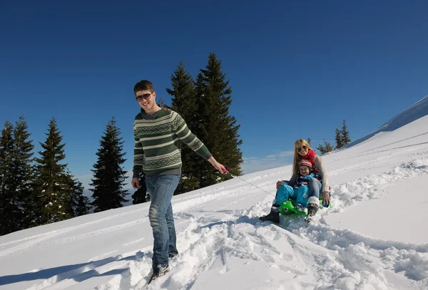 Family having fun on fresh snow at winter vacation — Stock Photo, Image