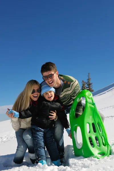 Family having fun on fresh snow at winter vacation — Stock Photo, Image