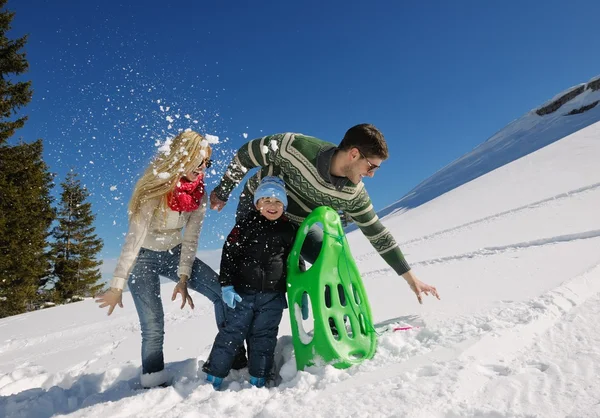 Family having fun on fresh snow at winter vacation — Stock Photo, Image