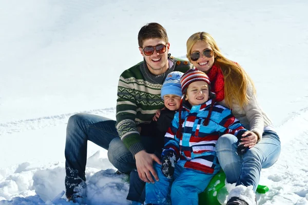 Family having fun on fresh snow at winter vacation — Stock Photo, Image