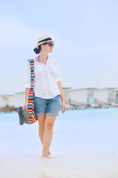 Mooie vrouw lopen op terug uitzicht op het strand — Stockfoto