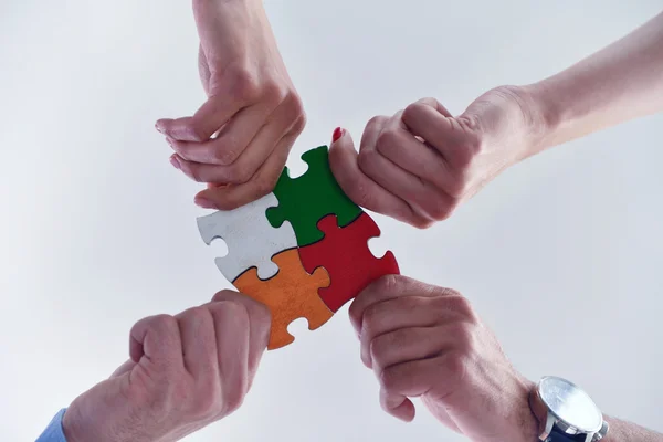 Group of business people assembling jigsaw puzzle — Stock Photo, Image