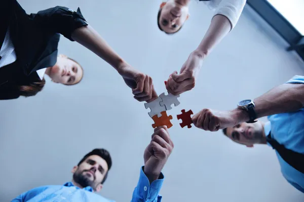 Group of business people assembling jigsaw puzzle — Stock Photo, Image