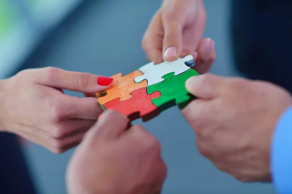 Group of business people assembling jigsaw puzzle — Stock Photo, Image