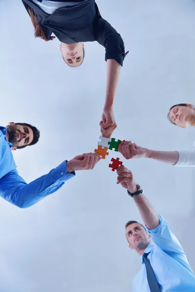 Group of business people assembling jigsaw puzzle — Stock Photo, Image