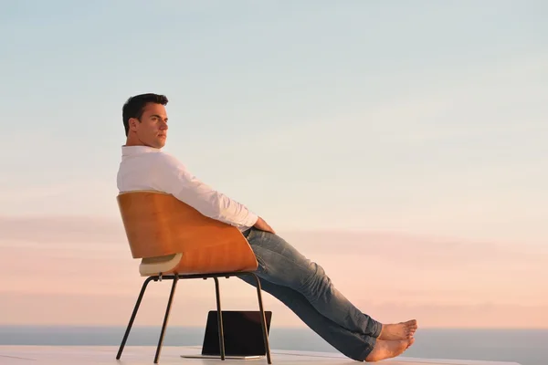 Young man on balcony — Stock Photo, Image