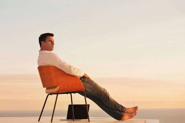 Young man on balcony — Stock Photo, Image