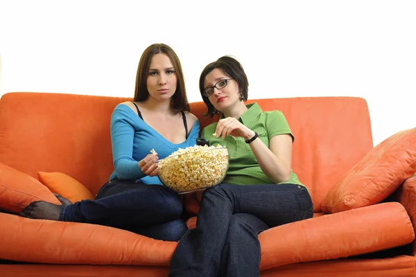 Друзья едят попкорн и смотрят телевизор — стоковое фото