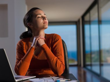 evde dizüstü bilgisayar üzerinde çalışan kadın