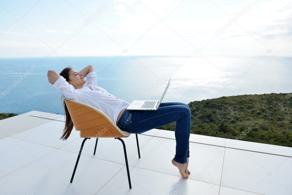 Woman working on laptop outdoors