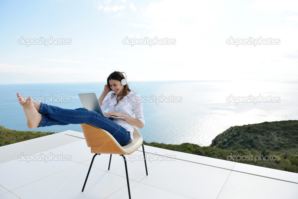 Woman working on laptop outdoors