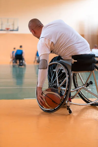 Weterani wojny niepełnosprawnej mieszane rasy i wieku drużyny koszykówki na wózkach inwalidzkich gra mecz treningowy w hali sportowej siłowni. Koncepcja rehabilitacji i integracji osób niepełnosprawnych — Zdjęcie stockowe