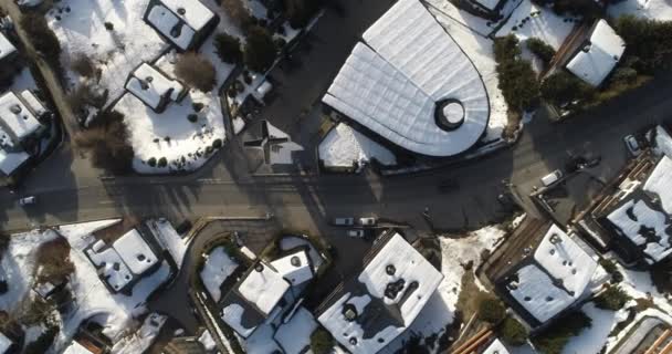 Aerial shot of a village in Switzerland that was covered in snow at a popular destination for skiers — Stock Video