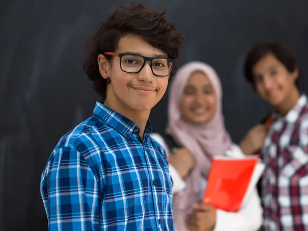 Arabic teenagers team, students group working together on laptop and tablet computer online classroom education concept. Selective focus Stock Photo