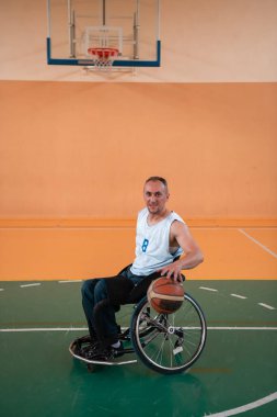 Modern bir spor salonunda basketbol oynayan bir savaş gazisinin fotoğrafı. Engelliler için spor kavramı. Yüksek kalite fotoğraf