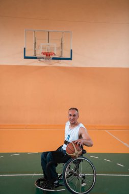Modern bir spor salonunda basketbol oynayan bir savaş gazisinin fotoğrafı. Engelliler için spor kavramı. Yüksek kalite fotoğraf
