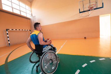 Engelli savaş gazileri ve tekerlekli sandalyeli yaş basketbol takımları spor salonunda antrenman yapıyorlar. Özürlülerin rehabilitasyonu ve kapsama konsepti