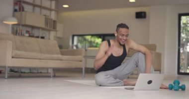 Afrikalı Amerikan fitness eğitmenleri dizüstü bilgisayarı müşteriyle çevrimiçi eğitim için ya da koronavirüs salgını sırasında çevrimiçi fitness dersi için kullanırlar. Yüksek kalite 4k görüntü