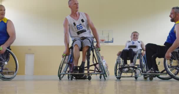 Persons with disabilities playing basketball in the modern hall. Slow motion — Stock Video
