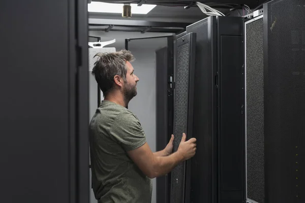 Engineer Working Server Room Data Center Technician Puts Rack New — стоковое фото