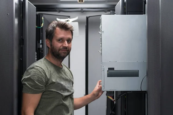 Engineer Working Server Room Data Center Technician Puts Rack New — стоковое фото