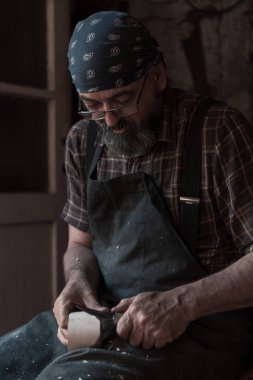 El yapımı ahşap ürünler ve aletlerle kaşık ustası atölyesinde çalışıyor. Yüksek kalite fotoğraf
