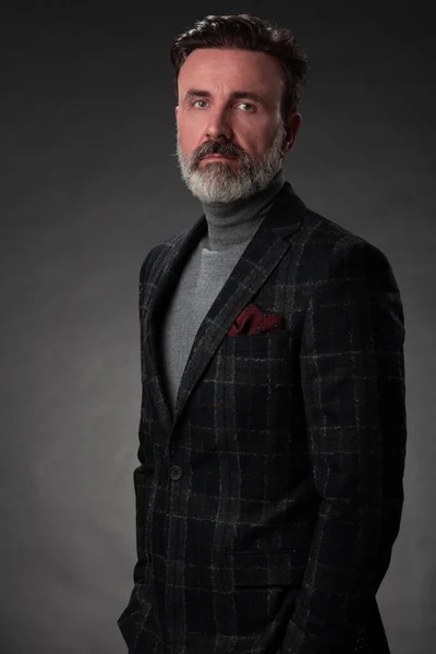 Portrait d'un élégant homme d'affaires élégant avec une barbe et des vêtements d'affaires décontractés dans un studio photo isolé sur fond sombre gesticulant avec les mains — Photo