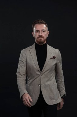 Kendinden emin bir işadamı, nedensel bir takım elbise giymiş, yakışıklı, kıdemli bir işadamı, siyah bir portrede çekilmiş bir kahraman.