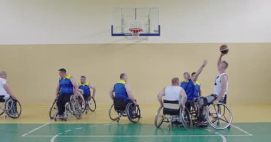 Engelli insanlar modern salonda basketbol oynarlar.