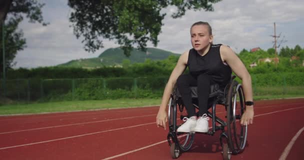 Žena se zdravotním postižením na invalidním vozíku na tréninkové dráze — Stock video