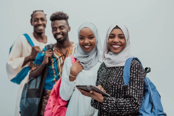 Photo of a group of happy african students talking and meeting together working on homework girls wearing traditional Sudanese Muslim hijab — Stock Photo, Image