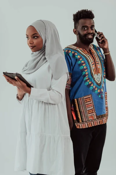 Young african business team woman wearing traditional sudan muslim hijab clothes using tablet computer isolated on white background students couple — Stock Photo, Image