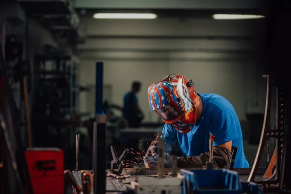 Professional Heavy Industry Welder Working Inside factory, Wears Helmet and Starts Welding. Selective Focus — Stok fotoğraf