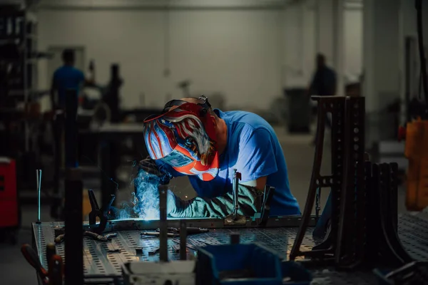 Professional Heavy Industry Welder Working Inside factory, Wears Helmet and Starts Welding. Selective Focus — Photo